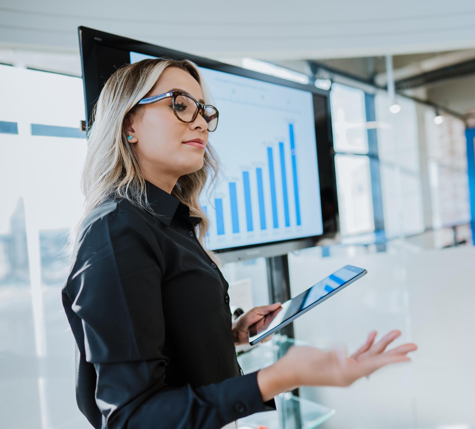 A businesswoman presenting business growth data.